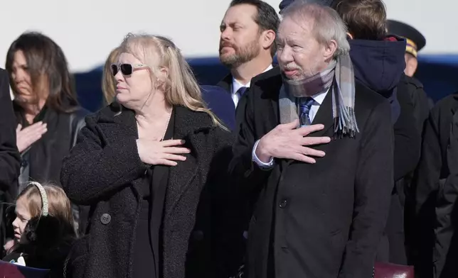 Amy Carter and Jeff Carter watch as the flag-draped casket of former President Jimmy Carter is placed on Special Air Mission 39 at Dobbins Air Reserve Base in Marietta, Ga., Tuesday, Jan. 7, 2025. Carter died Dec. 29 at the age of 100. (AP Photo/Alex Brandon, Pool)