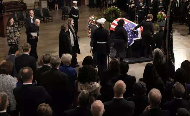 Members of the Carter family pay their respects as the flag-draped casket of former President Jimmy Carter lies in state at the U.S. Capitol, Tuesday, Jan. 7, 2025, in Washington. Carter died Dec. 29 at the age of 100. (AP Photo/J. Scott Applewhite, Pool)