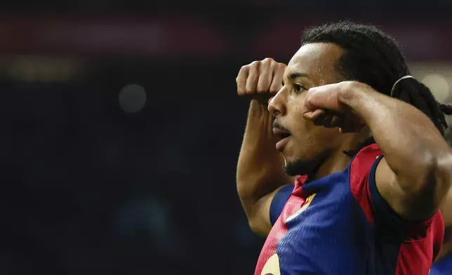 Barcelona's Jules Kounde celebrates after scoring his side's opening goal during a Spanish Copa del Rey round of 16 soccer match between Barcelona and Real Betis at the Lluis Companys Olympic Stadium in Barcelona, Spain, Wednesday, Jan. 15, 2025. (AP Photo/Joan Monfort)