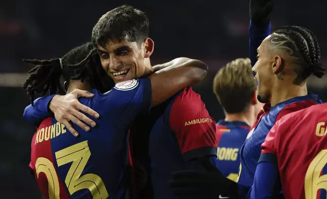 Barcelona's Jules Kounde, left, celebrates with teammates after scoring his side's opening goal during a Spanish Copa del Rey round of 16 soccer match between Barcelona and Real Betis at the Lluis Companys Olympic Stadium in Barcelona, Spain, Wednesday, Jan. 15, 2025. (AP Photo/Joan Monfort)
