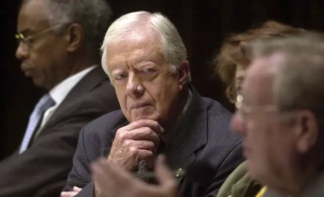 FILE - Former President Jimmy Carter, center, listens to a speech by former President of Costa Rica Rodrigo Carazo Odio, right, at the opening of the Joan B. Kroc Institute For Peace and Justice on the campus of the University of San Diego, in San Diego, on Dec. 6, 2001. (AP Photo/Denis Poroy, File)