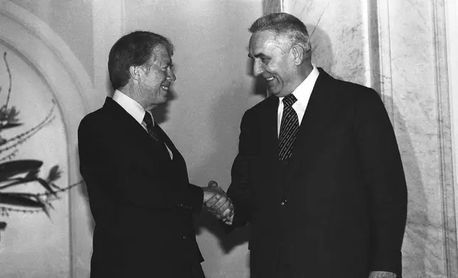 FILE - President Jimmy Carter and Polish First Secretary Edward Gierek shake hands after their formal talks in Warsaw on Dec. 30, 1977. (AP Photo, File)