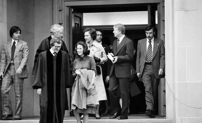 FILE - President Jimmy Carter and Rosalynn Carter chat with Rev. Charles Trentham as they leave the First Baptist Church in Washington on March 20, 1977. (AP Photo/Charles W. Harrity, File)