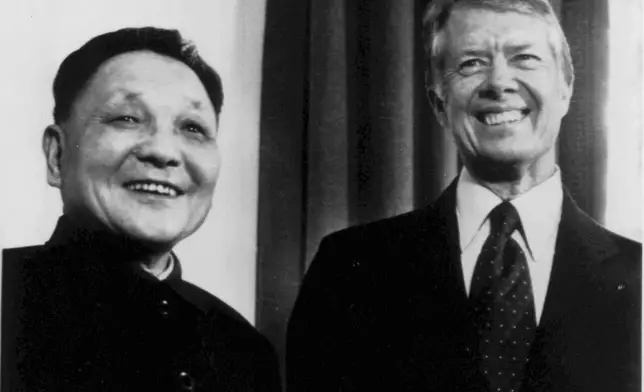 FILE - Chinese Vice Premier Deng Xioaping and President Jimmy Carter smile as they face photographers in the Oval Office in Washington on Jan. 29, 1979. (AP Photo, File)