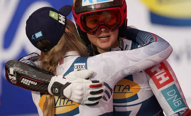 Norway's Kajsa Vickhoff Lie and Marte Monsen embrace after completing an alpine ski, women's World Cup super G, in Garmisch, Germany, Sunday, Jan. 26, 2025. (AP Photo/Piermarco Tacca)