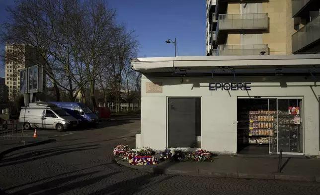 Wreaths lie in front of the Hypercacher Supermarket after commemorations marking 10 years since an Islamist attack on the Charlie Hebdo satirical newspaper and the Hypercacher jewish supermarket, in Paris Tuesday Jan. 7, 2025. (AP Photo/Thibault Camus)