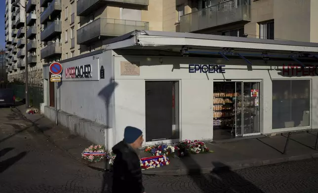 Wreaths lie in front of the Hypercacher Supermarket after commemorations marking 10 years since an Islamist attack on the Charlie Hebdo satirical newspaper and the Hypercacher jewish supermarket, in Paris Tuesday Jan. 7, 2025. (AP Photo/Thibault Camus)