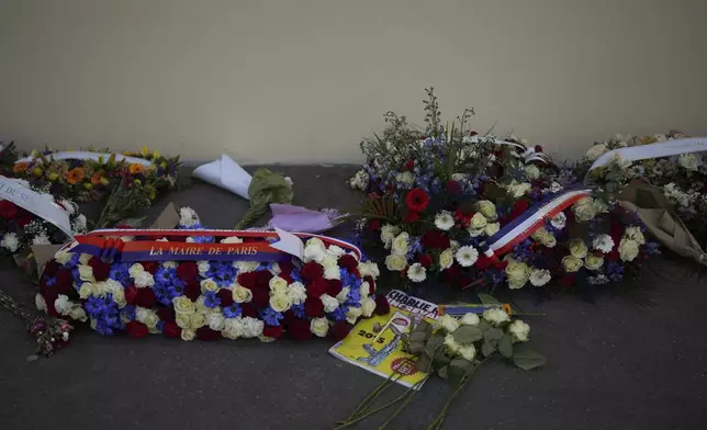 Wreaths are placed in front of Charlie Hebdo's former offices during commemorations marking 10 years since an Islamist attack on the Charlie Hebdo satirical newspaper and the Hypercacher jewish supermarket, in Paris Tuesday Jan. 7, 2025. (AP Photo/Thibault Camus)