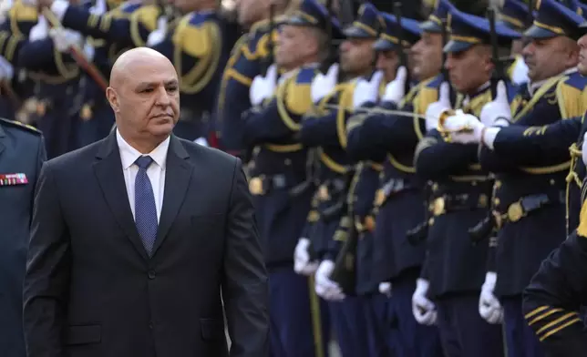 Newly-elected Lebanese President Joseph Aoun reviews the honor guard upon his arrival at the Lebanese Parliament to be sworn in as a new president, in Beirut, Lebanon, Thursday, Jan. 9, 2025. (AP Photo/Hussein Malla)