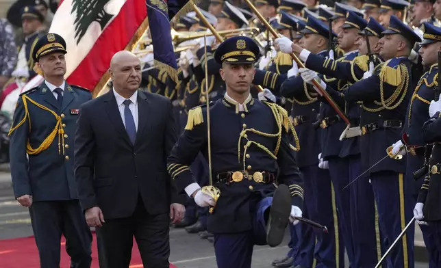 Newly-elected Lebanese President Joseph Aoun, center, reviews the honor guard upon his arrival at the Lebanese Parliament to be sworn in as a new president, in Beirut, Lebanon, Thursday, Jan. 9, 2025. (AP Photo/Hussein Malla)