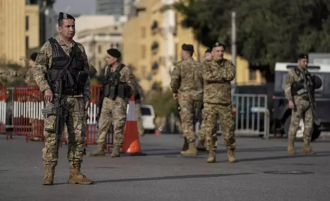 Lebanese army soldiers block a road that leads to the parliament building while lawmakers gather to elect a president in Beirut, Lebanon, Thursday, Jan. 9, 2025. (AP Photo/Bilal Hussein)