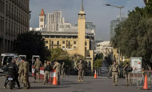 Lebanese army soldiers block a road that leads to the parliament building while lawmakers gather to elect a president in Beirut, Lebanon, Thursday, Jan. 9, 2025. (AP Photo/Bilal Hussein)