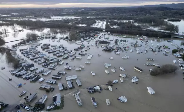 Caravans and cars sit in the floods of the river Soar in Barrow Upon Soar, England, Tuesday, Jan. 7, 2025.(AP Photo/Darren Staples)