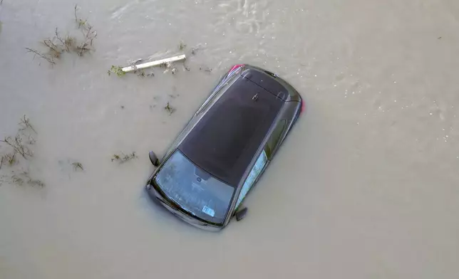 A car sits in the floods of the river Soar in Barrow Upon Soar, England, Tuesday, Jan. 7, 2025.(AP Photo/Darren Staples)