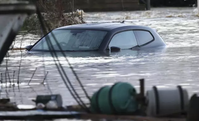 A car sits in the floods of the river Soar in Barrow Upon Soar, England, Tuesday, Jan. 7, 2025.(AP Photo/Darren Staples)