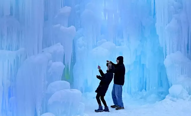 Nearly-made ice formations appear a glacial blue during daylight hours at the Ice Castles, Friday, Jan. 10, 2025, in North Woodstock, N.H. (AP Photo/Robert F. Bukaty)