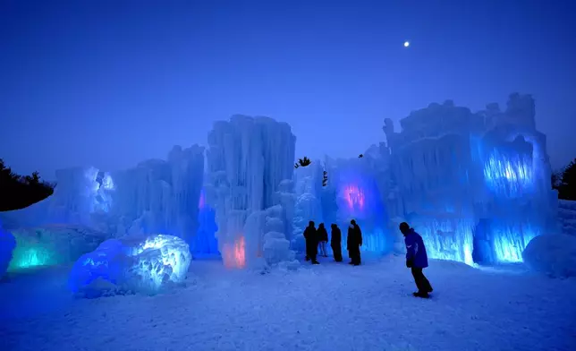 Lights embedded in ice formations glow at dusk, Friday, Jan. 10, 2025, in North Woodstock, N.H. (AP Photo/Robert F. Bukaty)