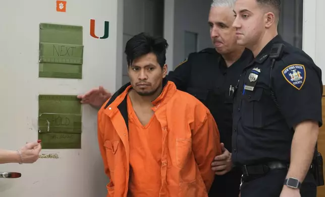 Sebastian Zapeta, accused of burning a woman to death inside a New York City subway train, left, is escorted into Kings County Supreme Court for an arraignment, Tuesday, Jan. 7, 2025, in New York. (AP Photo/Seth Wenig)