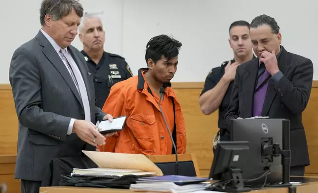 Sebastian Zapeta, center, accused of burning a woman to death inside a New York City subway train, appears in Kings County Supreme Court for an arraignment, Tuesday, Jan. 7, 2025, in New York. (AP Photo/Seth Wenig)