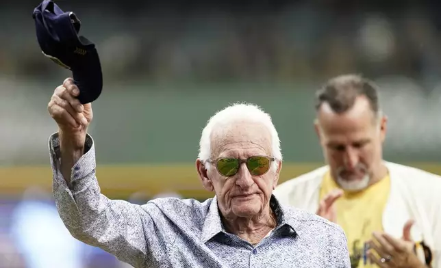FILE - Milwaukee Brewers radio announcer Bob Uecker tips his cap before a baseball game between the Milwaukee Brewers and the Miami Marlins,, July 28, 2024, in Milwaukee. (AP Photo/Aaron Gash)