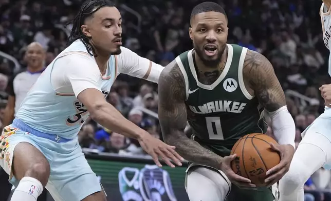 Milwaukee Bucks' Damian Lillard gets past San Antonio Spurs' Tre Jones during the first half of an NBA basketball game Wednesday, Jan. 8, 2025, in Milwaukee. (AP Photo/Morry Gash)