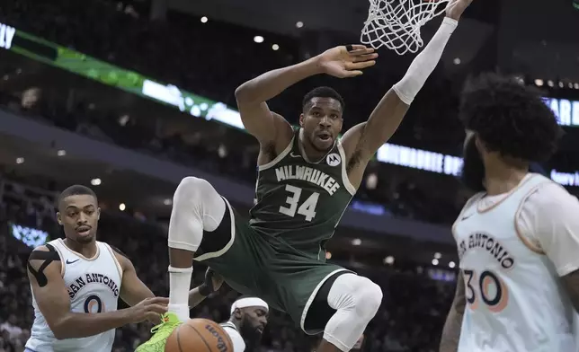 Milwaukee Bucks' Giannis Antetokounmpo dunks during the first half of an NBA basketball game Wednesday, Jan. 8, 2025, in Milwaukee. (AP Photo/Morry Gash)