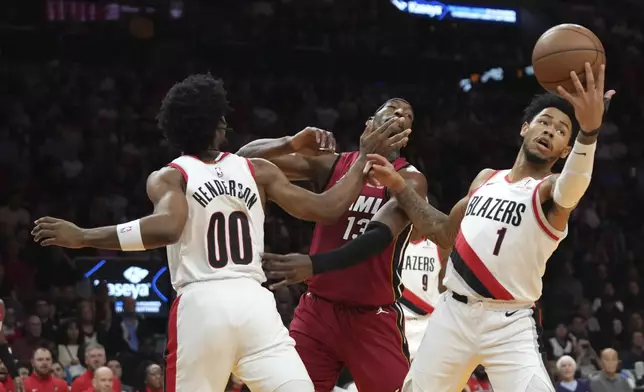 Portland Trail Blazers guard Anfernee Simons (1) goes for a loose ball against Miami Heat center Bam Adebayo during the first half of an NBA basketball game, Tuesday, Jan. 21, 2025, in Miami. (AP Photo/Lynne Sladky)