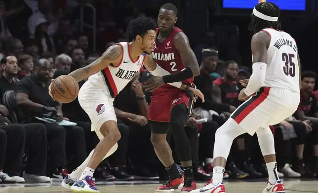 Miami Heat guard Terry Rozier (2) defends against Portland Trail Blazers guard Anfernee Simons during the first half of an NBA basketball game, Tuesday, Jan. 21, 2025, in Miami. (AP Photo/Lynne Sladky)