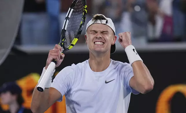 Holger Rune of Denmark celebrates after defeating Miomir Kecmanovic of Serbia in their third round match at the Australian Open tennis championship in Melbourne, Australia, Sunday, Jan. 19, 2025. (AP Photo/Vincent Thian)