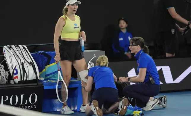 Danielle Collins of the U.S. gets her knee attended to during a third round match against Madison Keys of the U.S. at the Australian Open tennis championship in Melbourne, Australia, Saturday, Jan. 18, 2025. (AP Photo/Asanka Brendon Ratnayake)