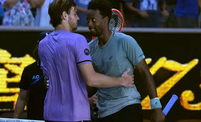 Gael Monfils, right, of France is congratulated by Taylor Fritz of the U.S. following their third round match at the Australian Open tennis championship in Melbourne, Australia, Saturday, Jan. 18, 2025. (AP Photo/Manish Swarup)