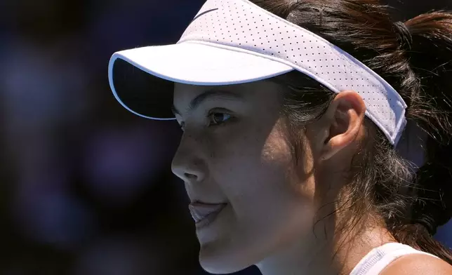 Emma Raducanu of Britain reacts during her third round match against Iga Swiatek of Poland at the Australian Open tennis championship in Melbourne, Australia, Saturday, Jan. 18, 2025. (AP Photo/Asanka Brendon Ratnayake)