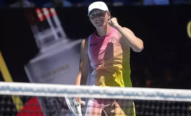 Iga Swiatek of Poland reacts after defeating Emma Raducanu of Britain in their third round match at the Australian Open tennis championship in Melbourne, Australia, Saturday, Jan. 18, 2025. (AP Photo/Asanka Brendon Ratnayake)