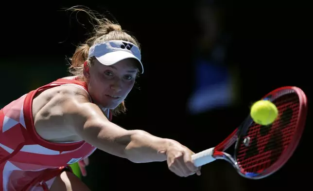 Elena Rybakina of Kazakhstan plays a backhand return to Dayana Yastremska of Ukraine during their third round match at the Australian Open tennis championship in Melbourne, Australia, Saturday, Jan. 18, 2025. (AP Photo/Ng Han Guan)