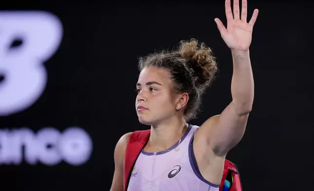 Jasmine Paolini of Italy waves as she leaves the court following her third round loss to Elina Svitolina of Ukraine at the Australian Open tennis championship in Melbourne, Australia, Saturday, Jan. 18, 2025. (AP Photo/Vincent Thian)