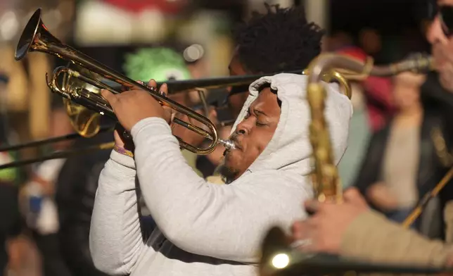 Mike Williams, of the One Way Brass Band, performs on Bourbon Street, Thursday, Jan. 2, 2025 in New Orleans. (AP Photo/George Walker IV)