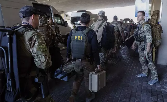 FBI personnel arrive at the Caesars Superdome ahead of the Sugar Bowl NCAA College Football Playoff game, Thursday, Jan. 2, 2025, in New Orleans. (AP Photo/Butch Dill)