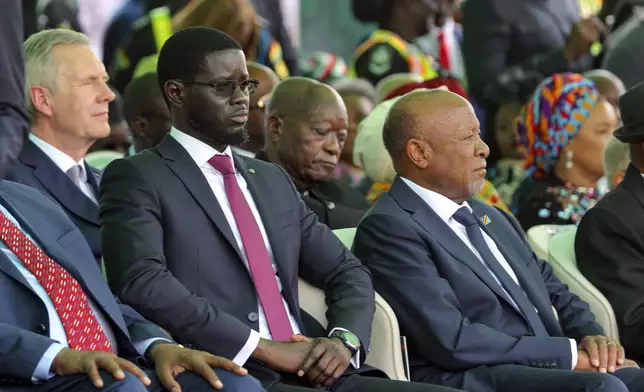 Senegal's President Bassirou Diomaye Faye, centre, is seen among the guests attending Ghana's President John Dramani Mahama inauguration ceremony, at the Independence Square in Accra, Ghana, Tuesday, Jan. 7, 2025. (AP Photo/Misper Apawu)