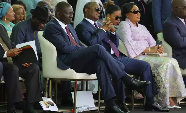 Kenya's President William Ruto, centre, is seen among the guests attending Ghana's President John Dramani Mahama inauguration ceremony, at the Independence Square in Accra, Ghana, Tuesday, Jan. 7, 2025. (AP Photo/Misper Apawu)