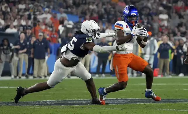 Penn State defensive end Amin Vanover (15) tackles Boise State running back Jambres Dubar (1) during the first half of the Fiesta Bowl NCAA college football CFP quarterfinal game, Tuesday, Dec. 31, 2024, in Glendale, Ariz. (AP Photo/Rick Scuteri)