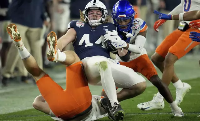 Penn State tight end Tyler Warren (44) is tackled by Boise State defensive end Max Stege (95) during the first half of the Fiesta Bowl NCAA college football CFP quarterfinal game, Tuesday, Dec. 31, 2024, in Glendale, Ariz. (AP Photo/Ross D. Franklin)