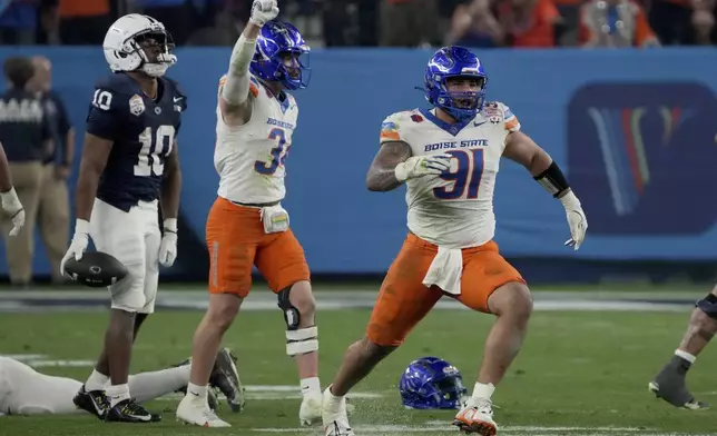 Boise State defensive end Ahmed Hassanein (91) celebrates a defensive stop against Penn State during the first half of the Fiesta Bowl NCAA college football CFP quarterfinal game, Tuesday, Dec. 31, 2024, in Glendale, Ariz. (AP Photo/Rick Scuteri)