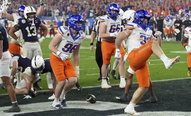 Boise State fullback Tyler Crowe (33) celebrates his touchdown against Penn State during the first half of the Fiesta Bowl NCAA college football CFP quarterfinal game, Tuesday, Dec. 31, 2024, in Glendale, Ariz. (AP Photo/Ross D. Franklin)