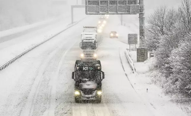 Vehicles on the A1(M) near Hopperton, north England, Sunday Jan. 5, 2025, as heavy overnight snow causes disruption across the UK as the cold start to the new year continues. (Danny Lawson/PA via AP)