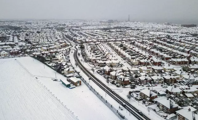 A blanket of snow covers houses in Blackpool, England, Sunday, Jan. 5, 2025. (Michael Holmes/PA via AP)