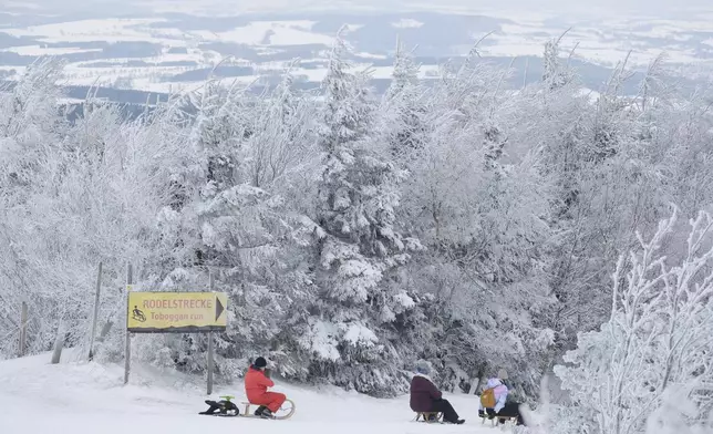 Tobogganers at the top of the Fichtelberg, Oberwiesentha, Germany, Saturday Jan. 4, 2025. (Sebastian Willnow/dpa via AP)