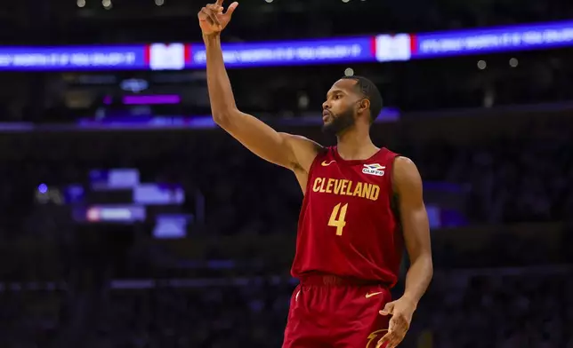 Cleveland Cavaliers forward Evan Mobley gestures after a 3-point basket during the first half of an NBA basketball game against the Los Angeles Lakers, Tuesday, Dec. 31, 2024, in Los Angeles. (AP Photo/Ryan Sun)