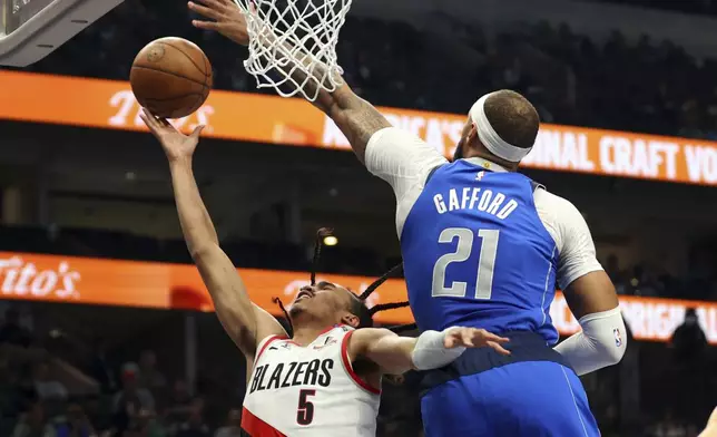 Portland Trail Blazers guard Dalano Banton (5) shots against Dallas Mavericks' Daniel Gafford (1) in the first half of an NBA basketball game Thursday, Jan. 9, 2025, in Dallas. (AP Photo/Richard W. Rodriguez)