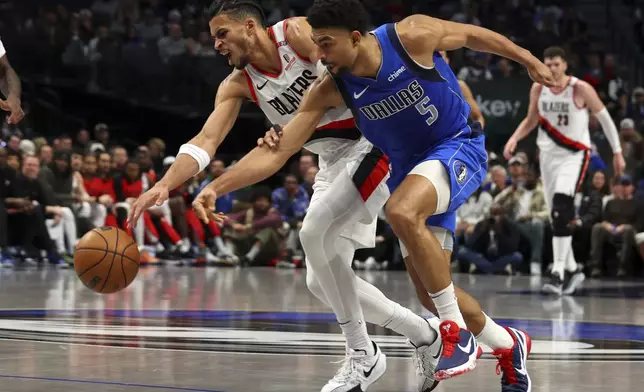 Portland Trail Blazers' Toumani Camara, left, has the ball tipped away by Dallas Mavericks' Quentin Grimes (5) in the first half of an NBA basketball game Thursday, Jan. 9, 2025, in Dallas. (AP Photo/Richard W. Rodriguez)