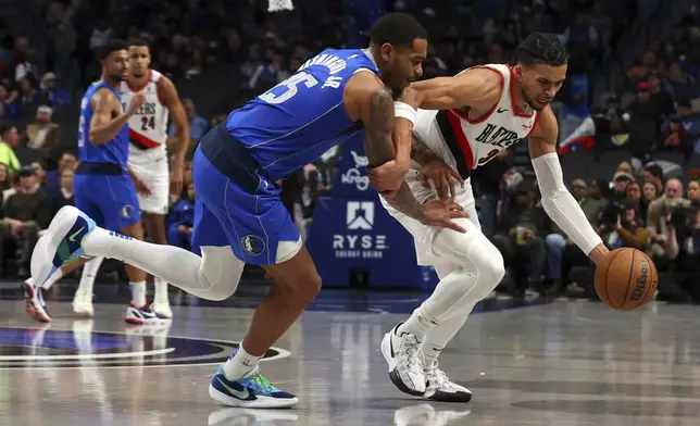 Dallas Mavericks' P.J. Washington gets his ball stolen by Portland Trail Blazers forward Toumani Camara in the first half of an NBA basketball game, Thursday, Jan. 9, 2025, in Dallas. (AP Photo/Richard W. Rodriguez)